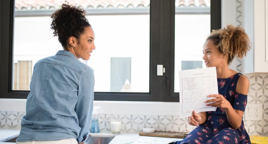 Mother and child in front of a window with an ADT contact sensor